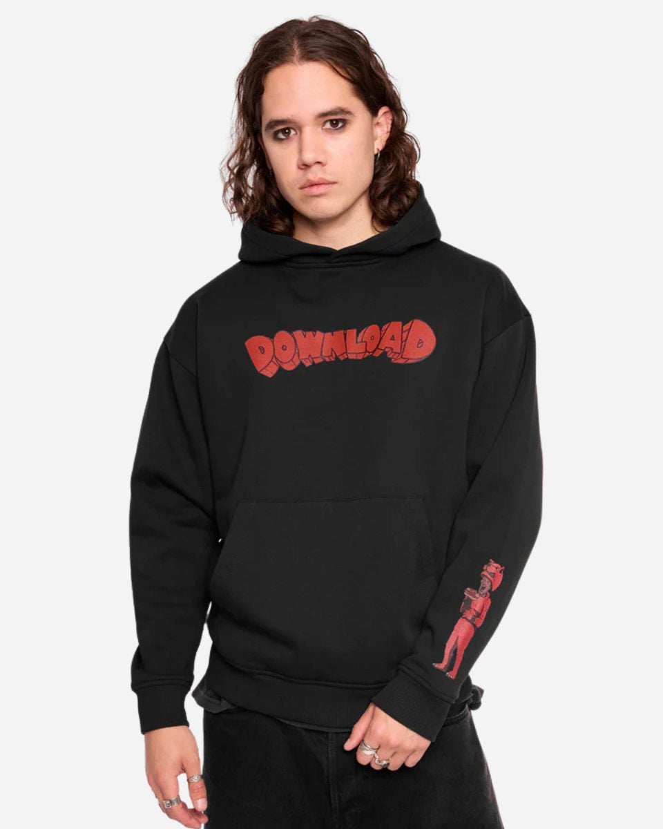 A person with shoulder-length brown hair models the Mary Wyatt Paradise Pullover Hoodie by Download Festival Shop, featuring DOWNLOAD in red cartoon letters on the chest and a red character graphic on the right sleeve, against a white background.