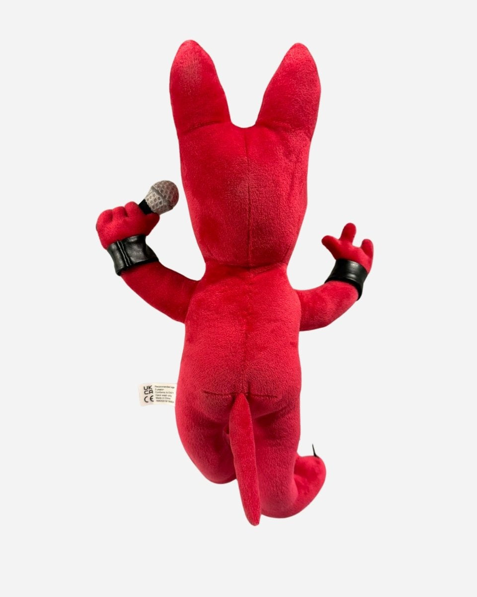 The 2025 Anime Plush Dog is a red plush toy with pointy ears, black wristbands, and a tail, holding a microphone in its right hand. The toy is displayed from the back against a plain white background.