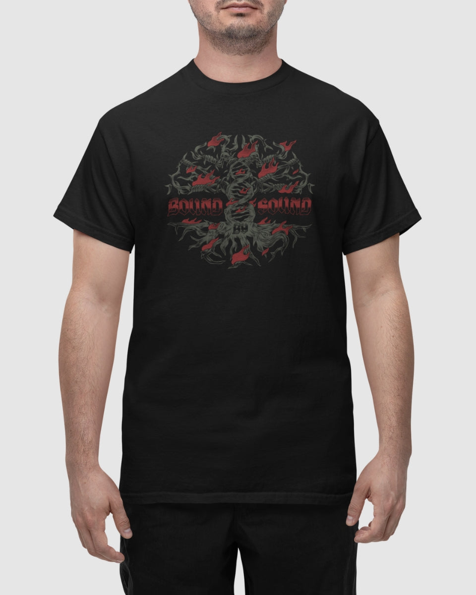 A man wears the Bound by Sound Black T-Shirt, showcasing an abstract dark green and red graphic with bold chest text. Crafted using eco-friendly processes, he stands with his arms relaxed at his sides.