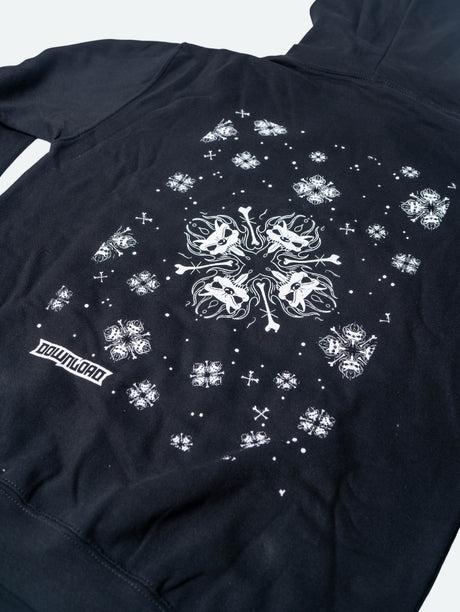 Close up back view of a black hoodie featuring a large central white snowflake design composed of mirrored snarling dog heads and crossed bones, surrounded by smaller matching snowflakes and symbols, with the Download logo near the hem.