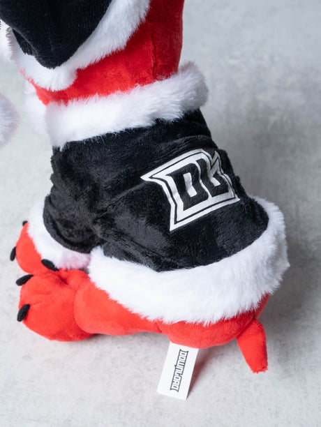 Close up of rear view of a red plush Download Dog toy dressed in a black and white Santa outfit, featuring a fluffy trim and a Santa hat, with a bold white "DL" logo on the back of the jacket.