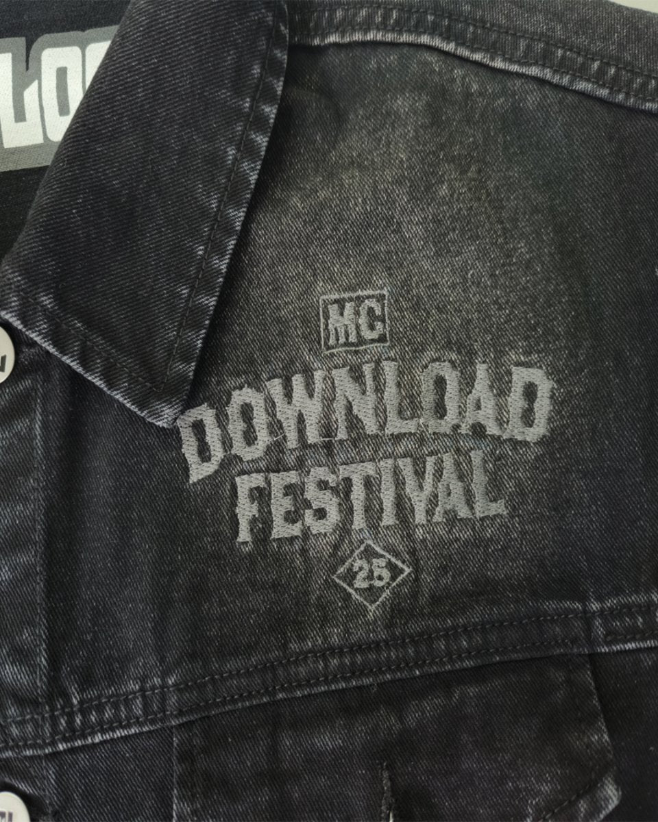 The 2025 Motorcycle Club Battle Jacket is a black denim jacket featuring white DOWNLOAD FESTIVAL and MC 23 text printed on the front under the collar.