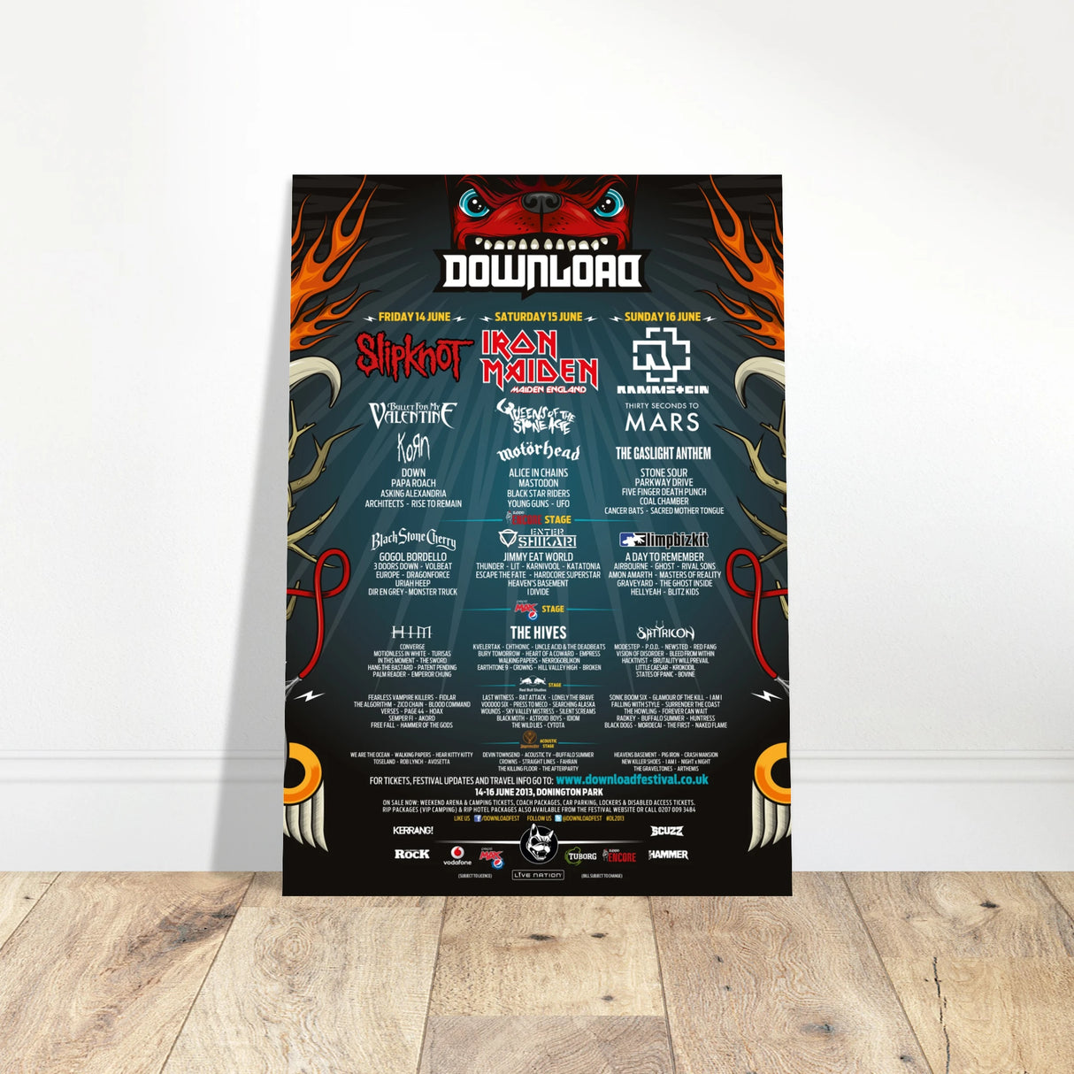 The Download Festival Shop’s “Download 2013 Line Up Poster A2” features flaming graphics, a red monster with teal eyes, Slipknot and Iron Maiden in the lineup, full event details, and is printed on FSC-certified semi-glossy paper.