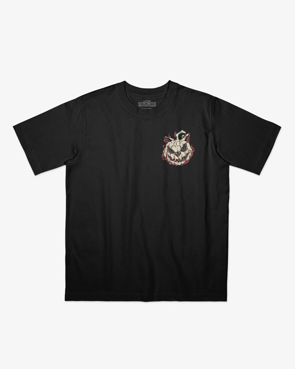 Download Admit One Soul Halloween T-shirt featuring a small front chest graphic of the Download dog carved as a sinister pumpkin, surrounded by flames, printed on a black T-shirt.