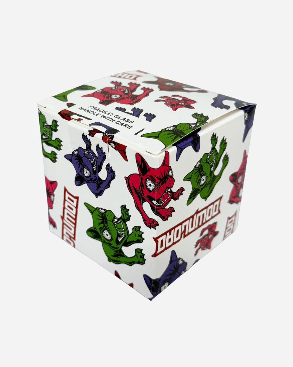A 12cm white Download Glass Bauble box by 2025, decorated with cartoon red, green, and purple monsters and "DADUMUDO" in bold. Includes a "FRAGILE GLASS HANDLE WITH CARE" warning for your glass bauble.