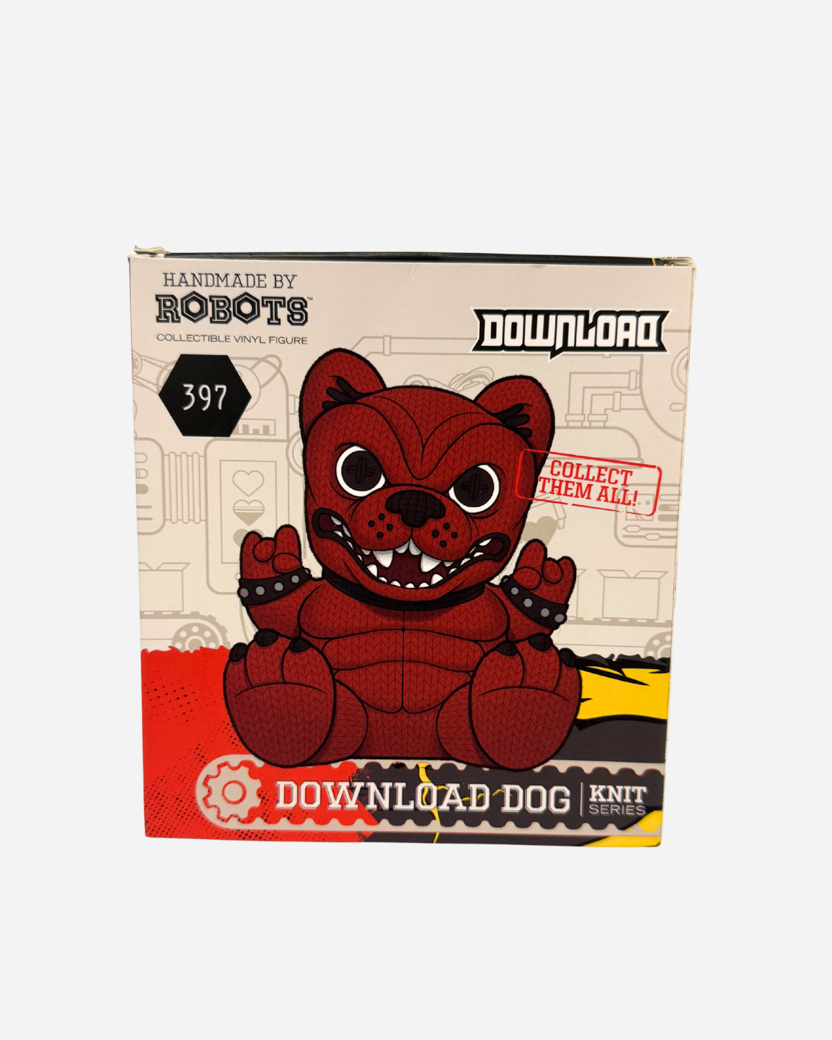 A box featuring the Hand Made by Robots Download Vinyl Dog from Download 2026, a red, cartoon-style dog figure with button eyes and paw pads, styled like a hand-knit toy, labeled “Collect Them All!” against a white and red background.