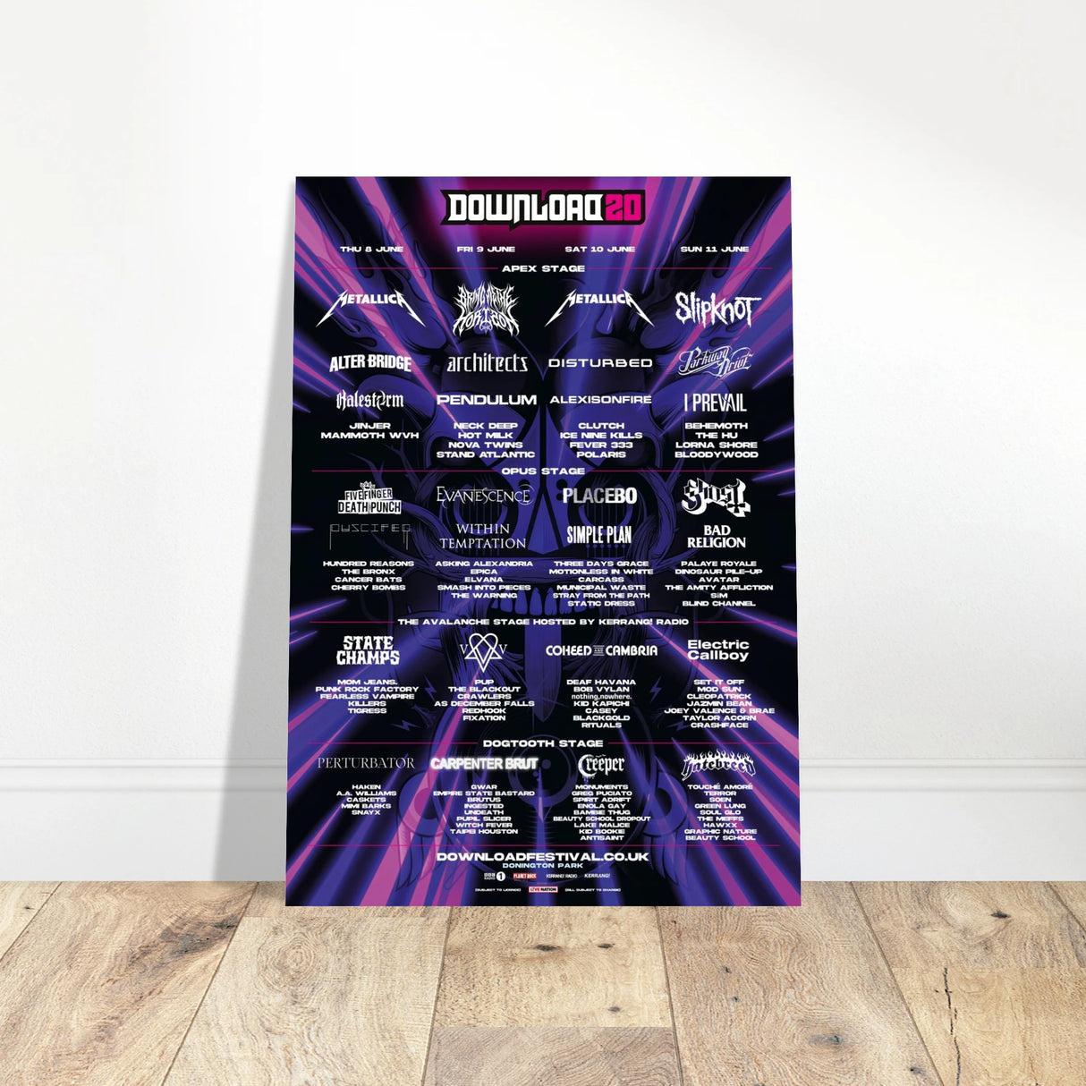 The Download 2023 Line Up Poster A2 from Download Festival Shop features bands like Metallica, Slipknot, and Bring Me The Horizon on a purple and black design, printed on semi-glossy paper and displayed against a white wall.