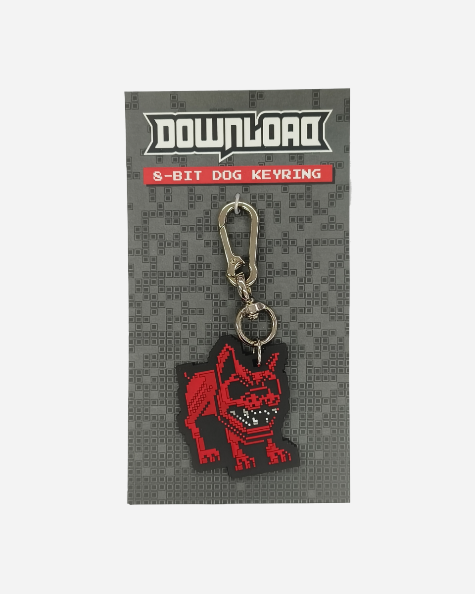 The Pixel Dog Keychain by Download 2026 features an 8-bit style red dog charm on a grey card labeled with the brand and product name, complete with a metal clasp and key ring.