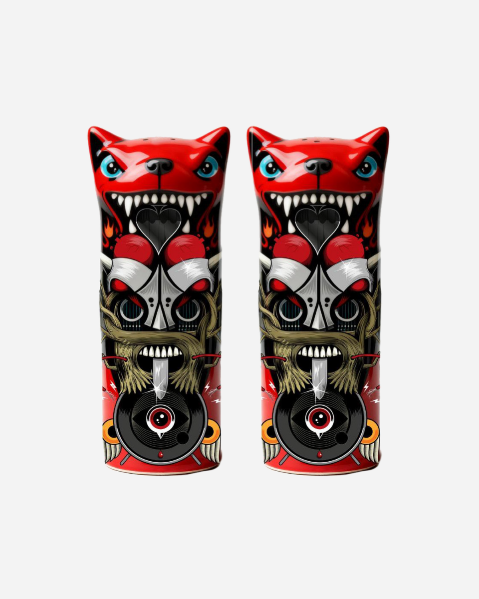 The Totem Salt and Pepper Shakers by Download 2026 feature two stylized cat figures with fierce expressions, sharp teeth, and detailed red, black, and gray tribal patterns on a white background.