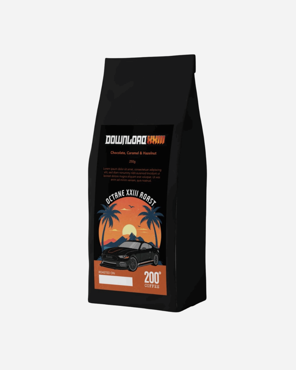 A black coffee bag from Download 2026, labeled Octane XXIII Roast, features a car, palm trees, and mountains. The label highlights chocolate, caramel, and hazelnut flavor notes.