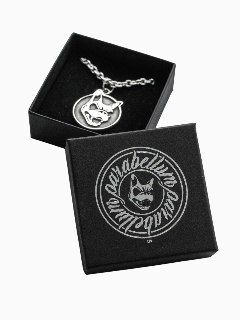 Sterling silver pendant necklace featuring a snarling dog head on a circular charm, displayed in a black gift box with “Parabellum LDN” branding and matching dog logo printed in silver on the lid.