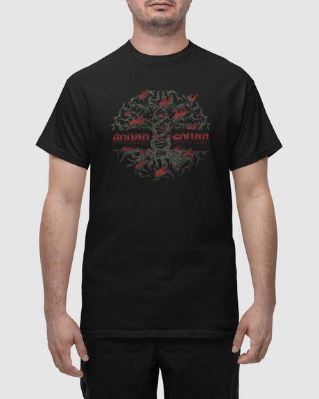 A man wears the Bound by Sound Black T-Shirt, showcasing an abstract dark green and red graphic with bold chest text. Crafted using eco-friendly processes, he stands with his arms relaxed at his sides.