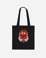 Introducing the Download Devil Dog Black Tote Bag from the Download Festival Shop: a black cotton tote bag showcasing a striking red devil dog face with flames above its head and sharp white teeth, all set against a plain white background. This made-to-order design blends bold style with the practicality of long handle tote bags.
