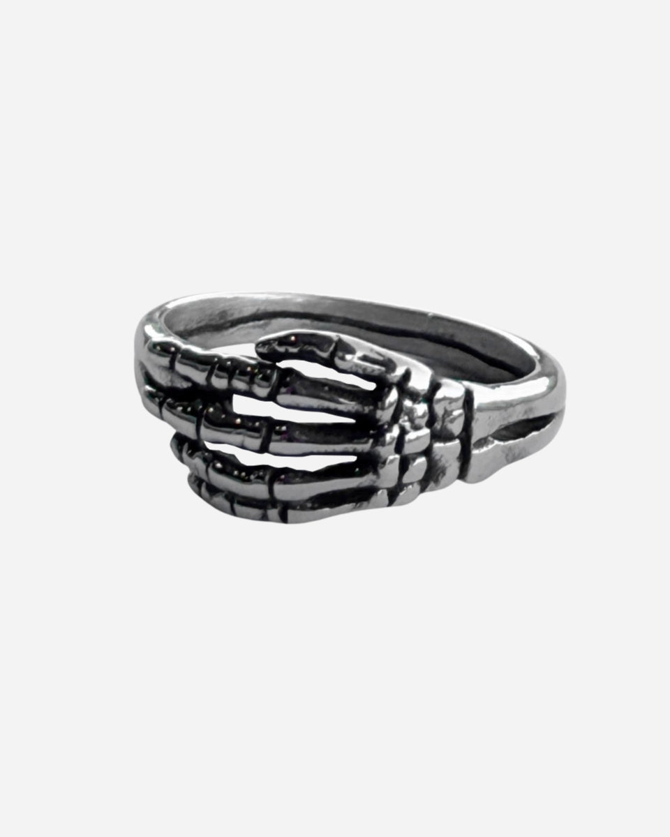 The Skeleton Ring by 2025 features a silver skeletal hand design that wraps around the finger, with detailed bone accents on a simple band.