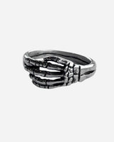 The Skeleton Ring by 2025 features a silver skeletal hand design that wraps around the finger, with detailed bone accents on a simple band.