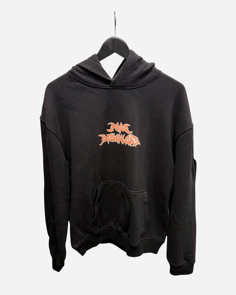 The P&Co Unisex Cerberus Hoodie by 2025 is a black hooded sweatshirt with a large front pocket, displayed on a hanger. It features a stylized orange and white graphic logo centered on the chest.