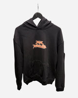 The P&Co Unisex Cerberus Hoodie by 2025 is a black hooded sweatshirt with a large front pocket, displayed on a hanger. It features a stylized orange and white graphic logo centered on the chest.