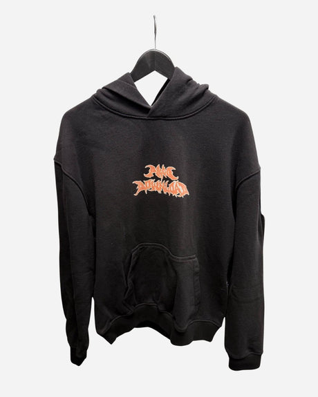 The P&Co Unisex Cerberus Hoodie by 2025 is a black hooded sweatshirt with a large front pocket, displayed on a hanger. It features a stylized orange and white graphic logo centered on the chest.