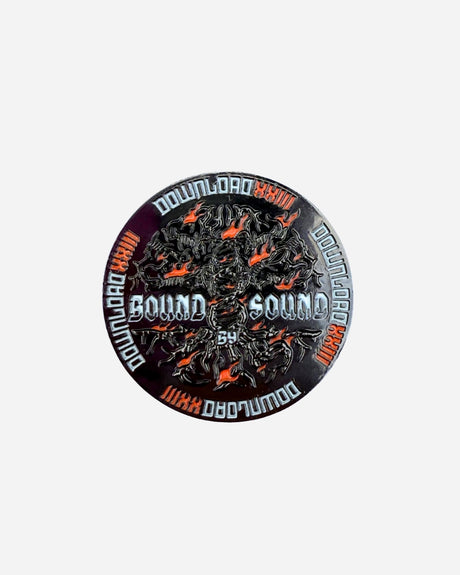 The Download Family Collector's Coin by 2025 is a limited edition round metal piece featuring "DOWNLOAD" repeated on the edge, "SOUND BY SOUND" in the center, and detailed black and orange flame-like designs.