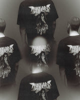 Five men, backs to the camera, wear 2026 P&Co Unisex Reaper Tees featuring a graphic of a woman in flames and the text “Download Season.” The image has a blurry, double-exposed effect.