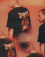 A person wearing the Download 2026 P&Co Unisex Cobra Tee, featuring a colorful graphic and brand name on the back, appears multiple times in a blurred, overlapping reddish-orange effect.