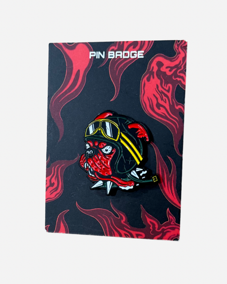 Download 2026 Pin Badge: Enamel pin featuring a snarling red bulldog with yellow goggles and a black spiked collar, displayed on a card with red flame designs and “PIN BADGE” at the top.