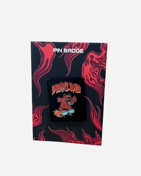 A vibrant pin badge from Download 2026 featuring a red, flaming creature on a skateboard, presented on a black card with striking red fire graphics and “PIN BADGE” displayed at the top.