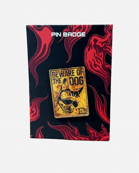 A “Beware of the Dog” Pin Badge by Download 2026, featuring a dog illustration on a yellow sign, displayed on a black and red flame-patterned card labeled “PIN BADGE” at the top.